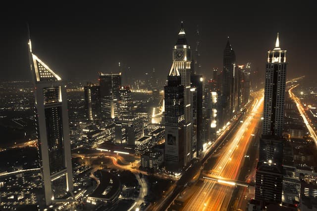 Dubai skyline at night with Burj Khalifa lit up, the view from thousands of expat apartments