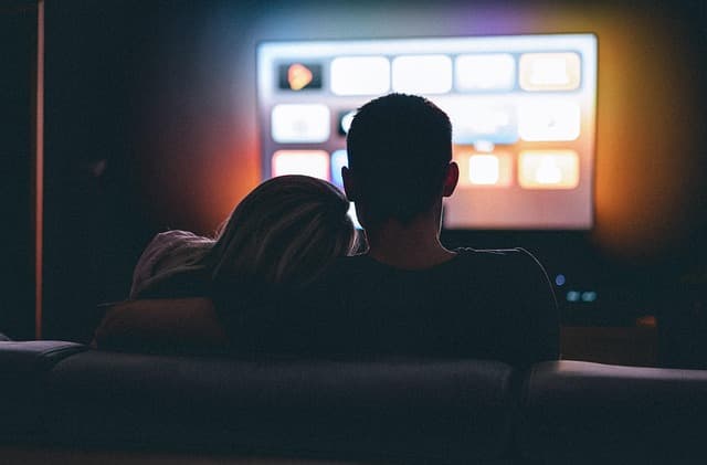 Couple on the sofa testing Rapid IPTV on movie night